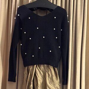 Black knit sweater w white pearls and reversible wrap design. Medium.